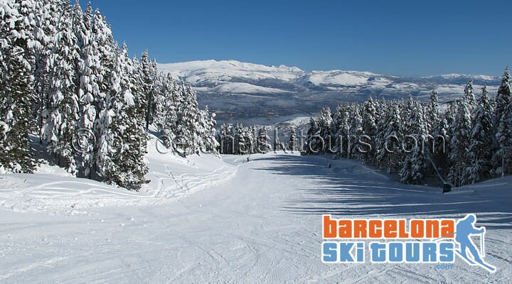 Masella pistes under morning sun with Pyrenean peaks behind